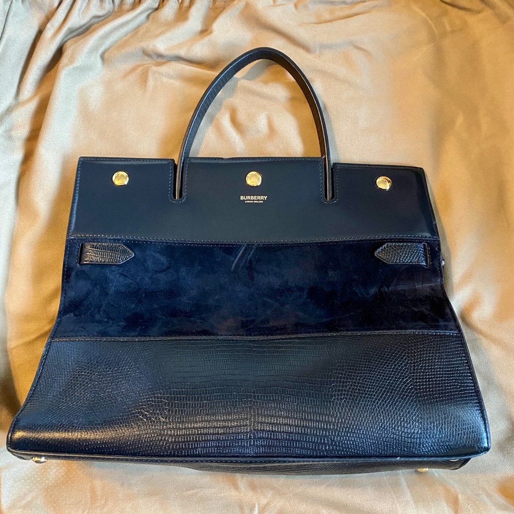 Burberry Bag and clutch wallet with detachable strap.